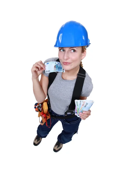 Blond electrician flashing her money — Stock Photo, Image