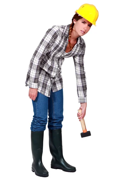 A tired female construction worker with a hammer. — Stock Photo, Image