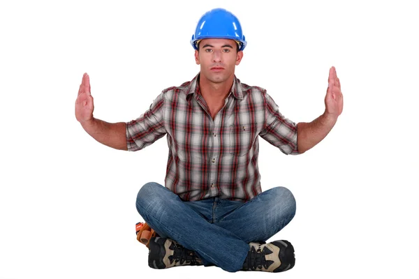 Austere tradesman leaning forward and holding up his arms — Stock Photo, Image