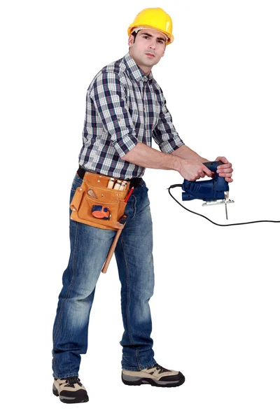 Full-length shot of young carpenter using sander machine — Stock Photo, Image