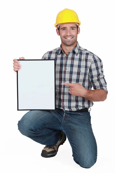 Craftsman pointing at a blank board — Stock Photo, Image