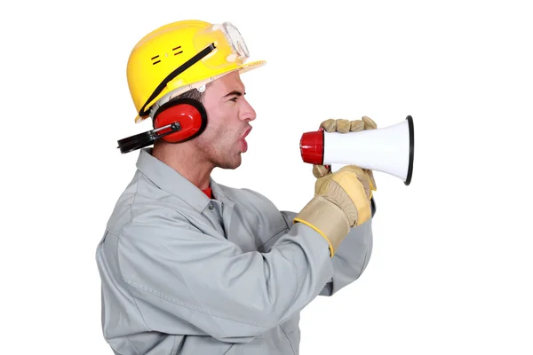 Manual worker shouting into megaphone — Stock Photo, Image