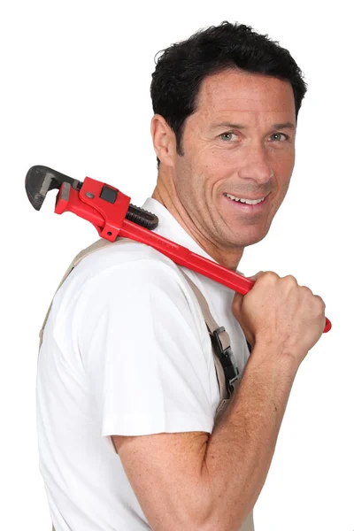 Labourer holding tool over shoulder — Stock Photo, Image