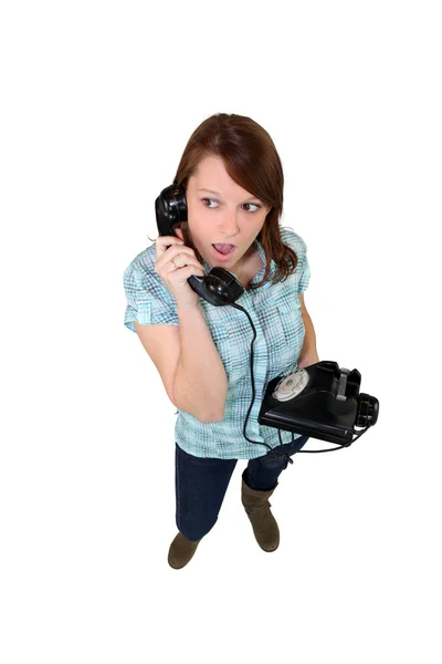 Young woman with a landline phone — Stock Photo, Image