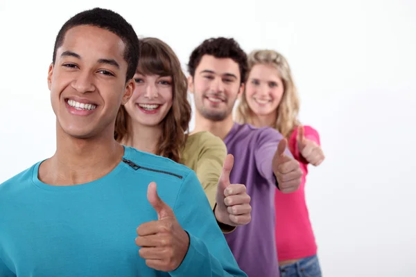 Group of young giving the thumbs-up — Stock Photo, Image