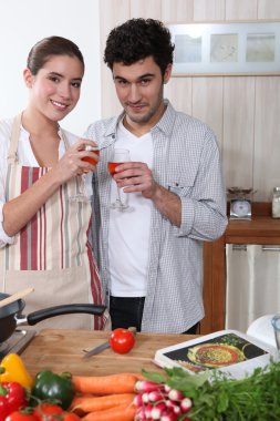 Young couple in a kitchen clipart