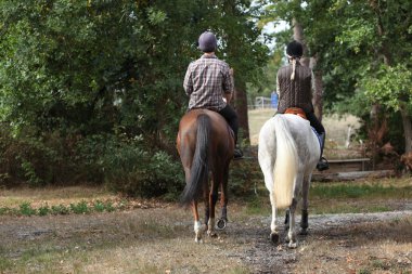 Couple riding in the countryside clipart