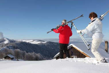 Senior couple on a ski vacation clipart