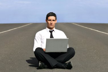 Man alone with laptop on airstrip clipart