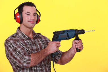 Man holding an electric screwdriver clipart