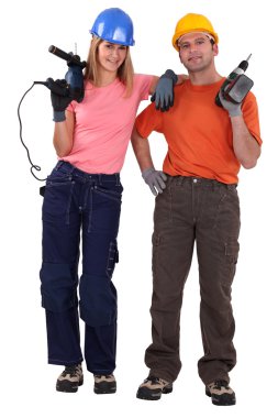 Couple stood with power drills clipart