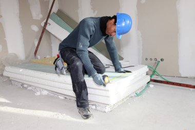 Worker using a measuring tape clipart