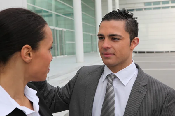 Young couple outside an office building — Stock Photo, Image