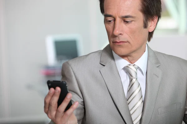 Businessman looking at phone — Stock Photo, Image