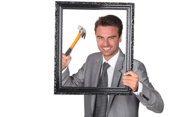 Agressive businessman with picture frame — Stock Photo, Image