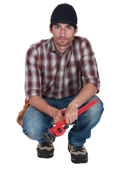 Crouching plumber — Stock Photo, Image