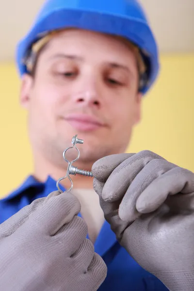 Plumber with a bracket for water pipes — Stock Photo, Image