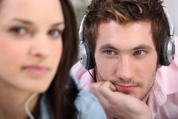 Man with headphones beholding his belle — Stock Photo, Image