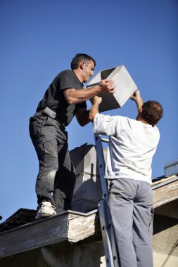 Roofers installing chimney clipart