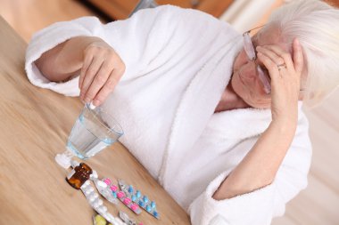 Elderly woman with various medications clipart