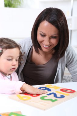 Woman playing with her child clipart