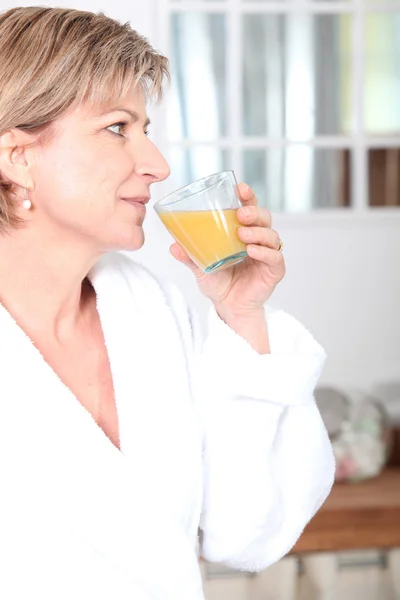 Bir bardak portakal suyu içen kadın. — Stok fotoğraf