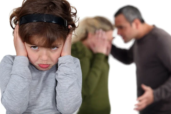 Little girl blocking out her parents' argument — Stock Photo, Image