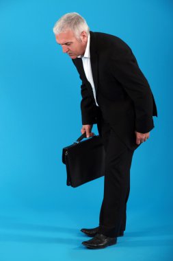Middle-aged businessman with briefcase clipart