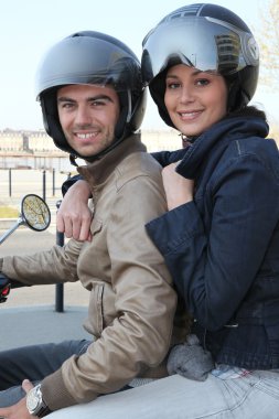 Couple riding a motorcycle clipart