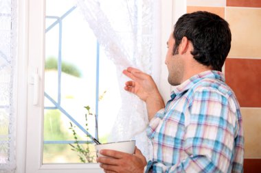 Man looking out window clipart