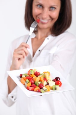 Woman eating fruit salad clipart