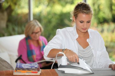 Girl ironing for mother clipart