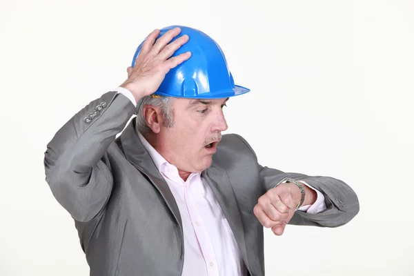 Mature architect consulting his watch — Stock Photo, Image