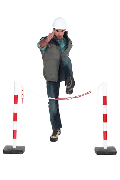Man jumping over chain — Stock Photo, Image