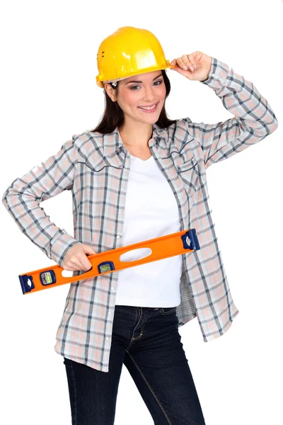 Chirpy female worker with spirit level — Stock Photo, Image