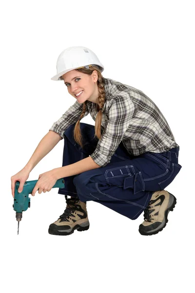 Kvinna anläggning drill — Stockfoto