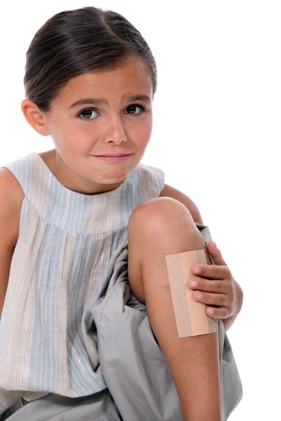 Young girl with an enormous plaster on her leg — Stock Photo, Image