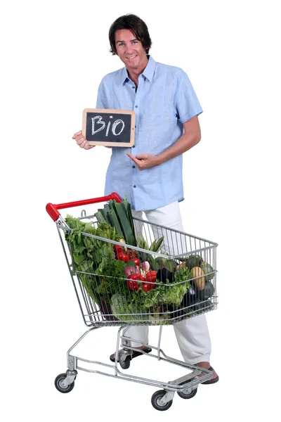 Man with a shopping trolley of organic produce — Stock Photo, Image