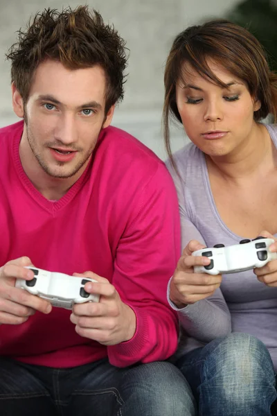 Pareja joven jugando videojuegos — Foto de Stock