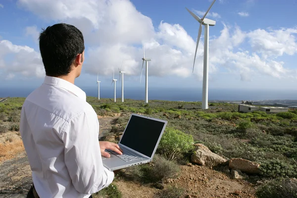 Man with laptop in wind farm — Stock Photo, Image