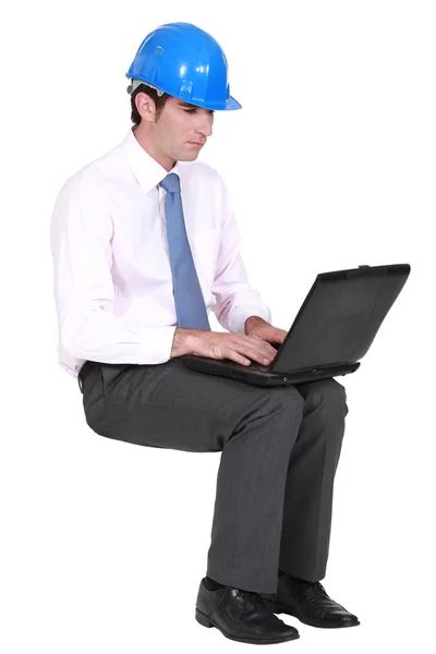 Architect sat typing notes on laptop Stock Image