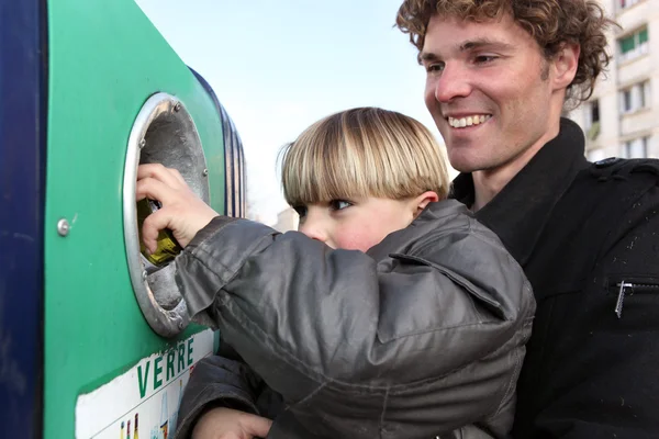 Father and son at a bottle bank — Stock Photo, Image