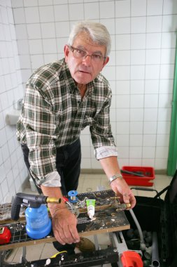 Plumber working in a shower room clipart