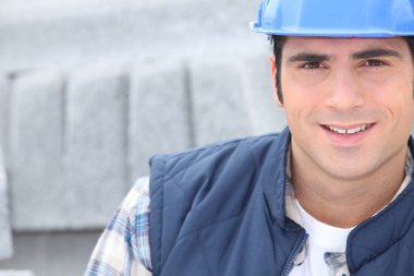Closeup of a construction worker with concrete curbing in the background clipart