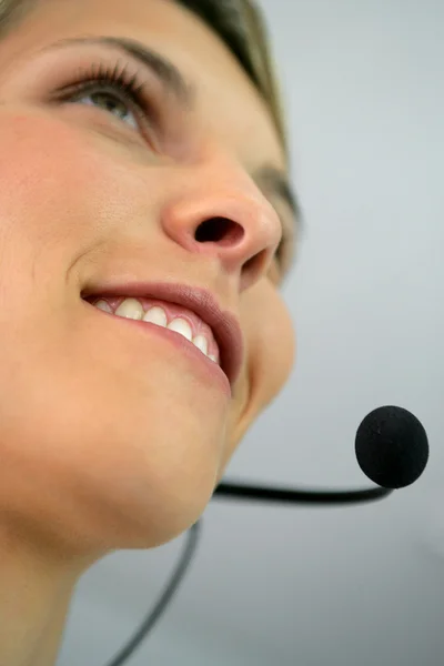 Close-up shot of a woman wearing a headset — Stock Photo, Image
