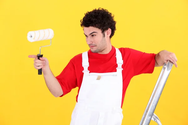 Man with paint roller and ladder — Stock Photo, Image