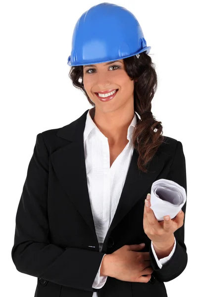 Engineer holding rolled up plans — Stock Photo, Image