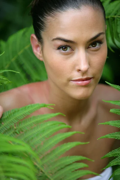 Frau in grünem Laub — Stockfoto