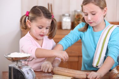 Two little girls baking clipart