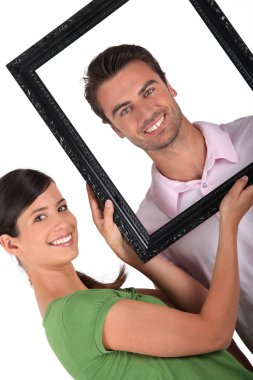 Couple with a picture frame clipart